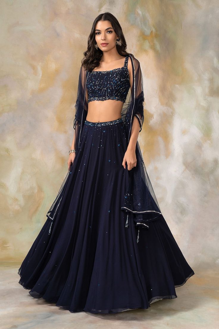 Midnight blue lehenga with embellished waistband. Comes with embellished blouse and dupatta.
Components: 3
Fabric: Georgette, Net
Neckline: Square
Sleeve Length: Sleeveless
Color: Blue
Embellished
Net dupatta 
Floral motif work
Tassel detail - Aza Fashions Lehenga Simple, Dupatta Styling, Navy Blue Lehenga, Diy Handbags, Desi Attire, Chikankari Lehenga, Sangeet Outfit, Simple Lehenga, Lehnga Dress