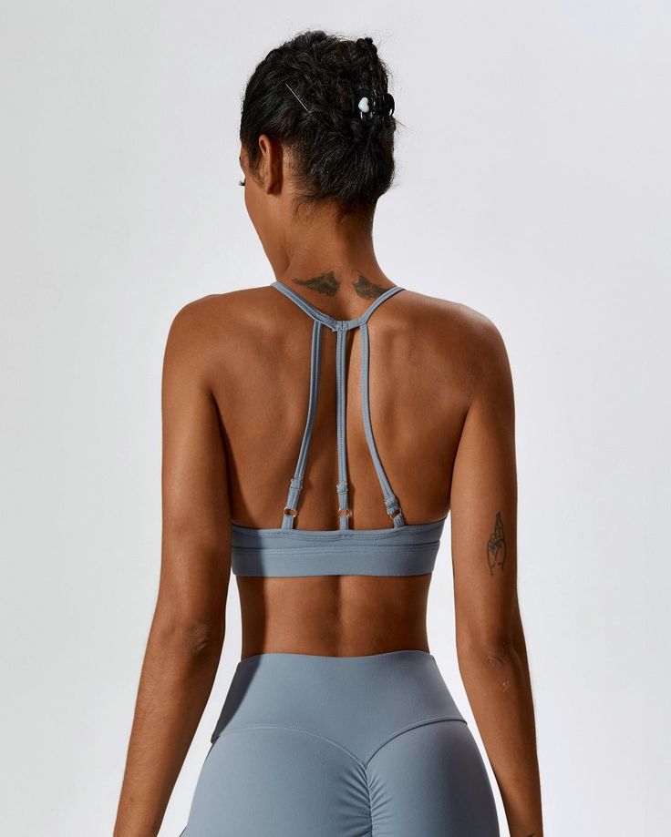 Haze Blue Strappy Sports Bra With Built-in Bra, T-back Sports Bra With Straps For Workout, Sports Bra With Strappy Back And Built-in Bra, Racerback Sports Bra For Pilates, Strappy Back Sports Bra For Workout, Workout Sports Bra With Strappy Back, Strappy Sports Bra With Adjustable Straps For Gym, Strappy Sports Bra With Adjustable Straps For Pilates, Adjustable Strappy Sports Bra For Gym