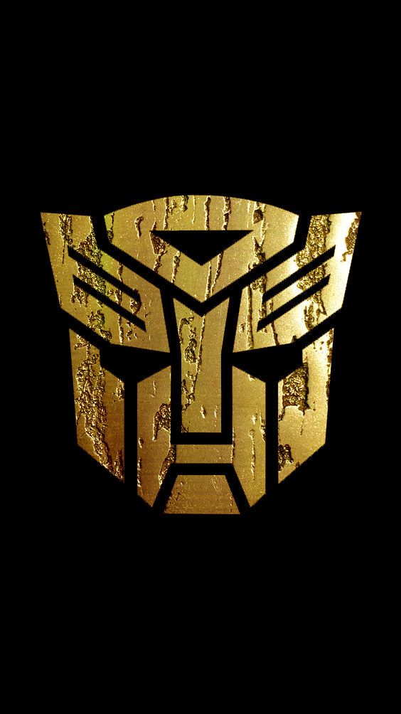 a golden logo on a black background that looks like the face of a transformer