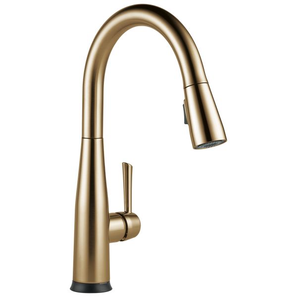 the kitchen faucet is shown in gold, and has an angled spout