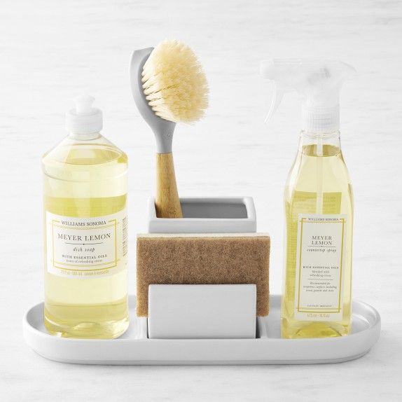 a bathroom set with soap, toothbrush and sponge on a tray next to it