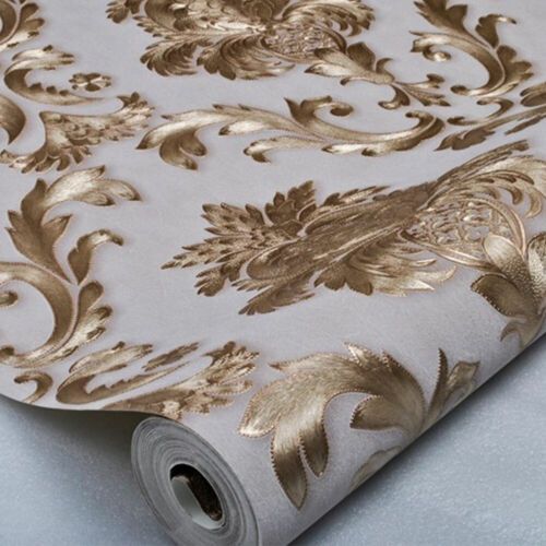 a white and gold wallpaper with an ornate design on the bottom half of it