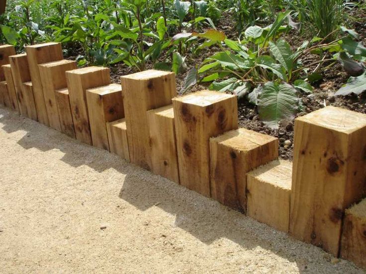 several wooden blocks are lined up in the dirt