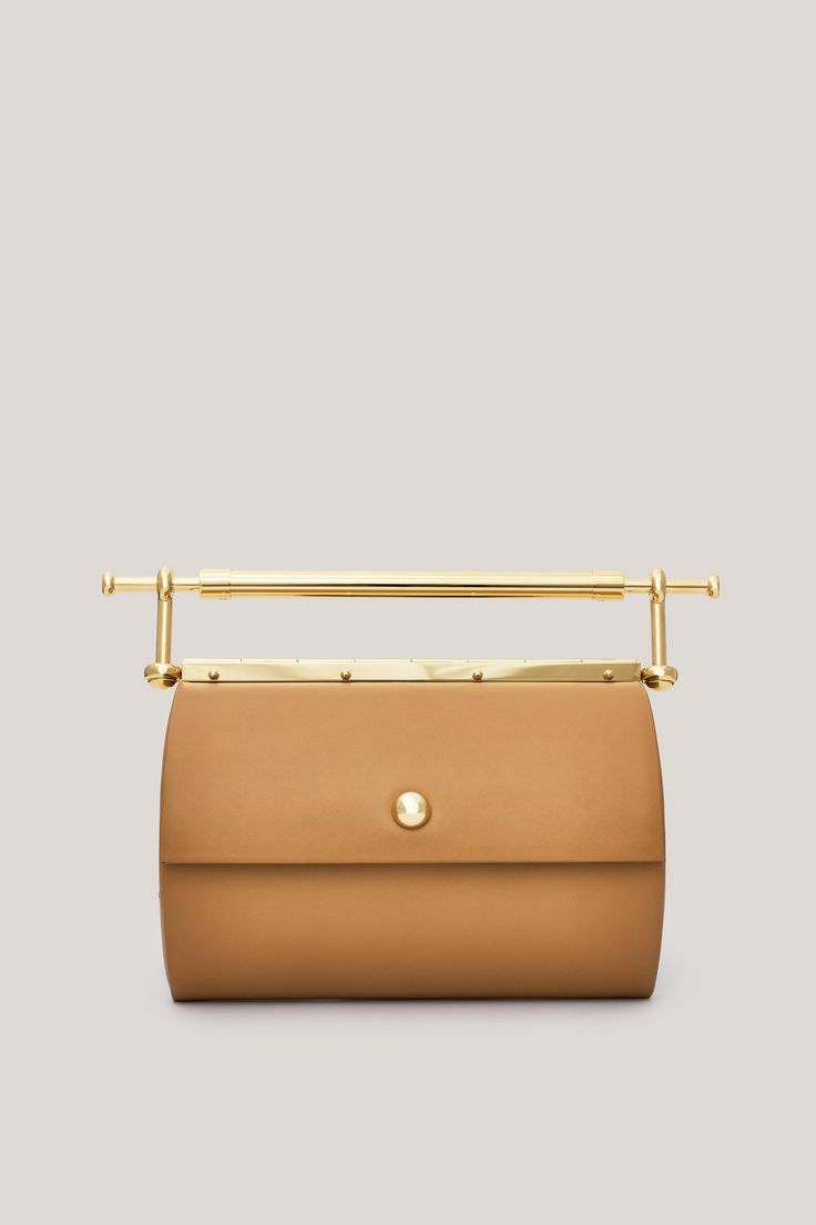 This is Gigi. Handmade in Italy, using only the highest quality materials, Gigi is a sleek clutch featuring the brand’s signature gold-coated hardware. With a unique design and surprisingly spacious interior, this handbag is the perfect blend of fashion and function. Wear it under the arm or carry it by the distinctive handle for an array of styling options. Gigi is a statement piece that can take you from day to night and is sure to command attention. Modern Gold Shoulder Bag With Metal Hardware, Luxury Beige Clutch With Detachable Strap, Chic Gold Clutch With Metal Hardware, Gold Leather Handheld Evening Bag, Luxury Rectangular Clutch With Detachable Handle, Luxury Clutch Box Bag With Top Carry Handle, Designer Handheld Clutch With Top Carry Handle, Chic Office Clutch With Top Carry Handle, Designer Brown Top Handle Clutch