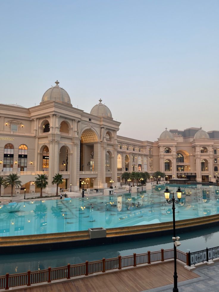 a large building with a pool in front of it