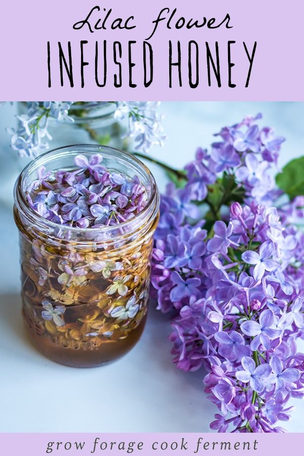 a jar filled with purple flowers sitting next to another jar