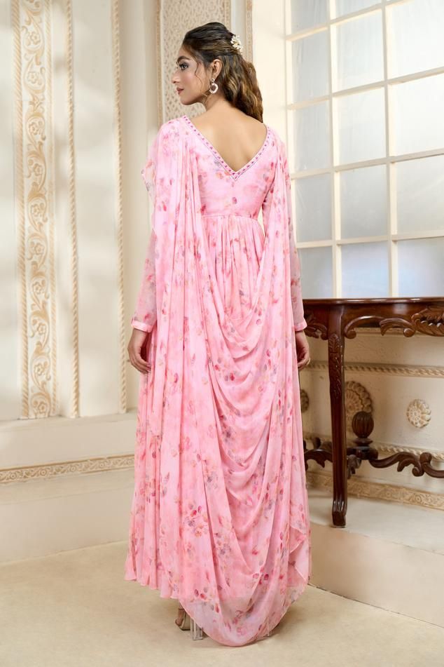 Pink rose petal inspired printed gown style anarkali with floral hand embroidered attached belt and dupatta style drapes.
Components: 1
Pattern: Printed, Embroidered
Type Of Work: Rose Petal, Floral
Neckline: V Neck
Sleeve Type: Full
Fabric: Chiffon
Color: Pink
Other Details: 
Tasseled waistband belt
Embroidered neckline
Attached lining
Closure: Side zip
Occasion: Destination Wedding,Sangeet - Aza Fashions Dupatta Style, Gown Style, Pink Chiffon, Embroidered Neckline, Rose Petals, Anarkali, Aza Fashion, Sleeve Type, Pink Rose