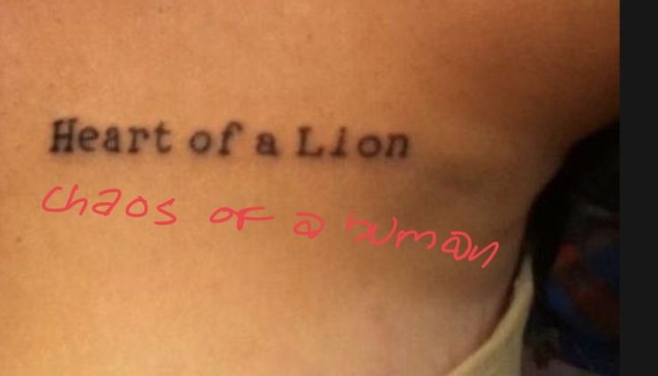 the back of a woman's stomach with words written on it that read, heart of a lion chaos of a human