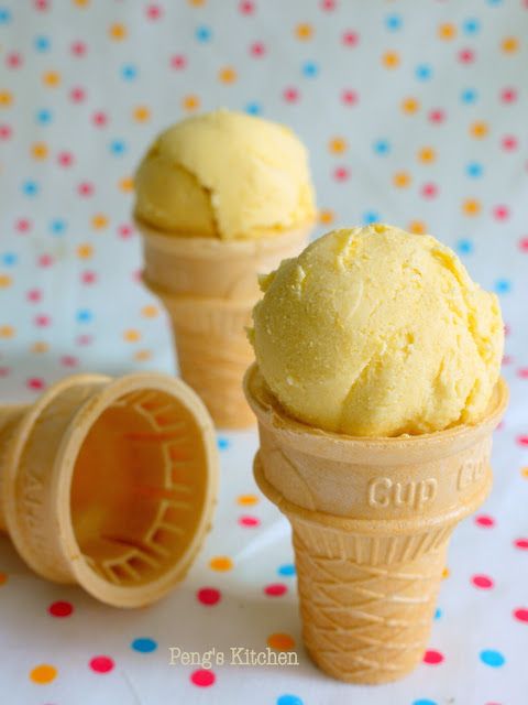 two scoops of ice cream sitting next to each other on a polka dot tablecloth