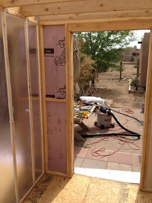 the inside of a house being built with construction materials on the ground and walls around it