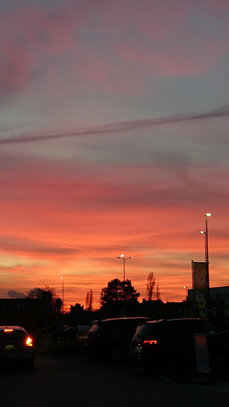 cars parked in a parking lot at sunset