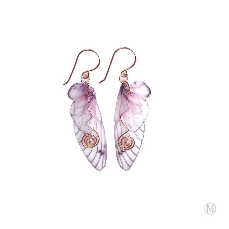 two pink and white butterfly wings hanging from copper earwires on a white background