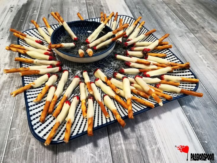 a blue plate topped with french fries on top of a wooden table next to a bowl filled with ketchup