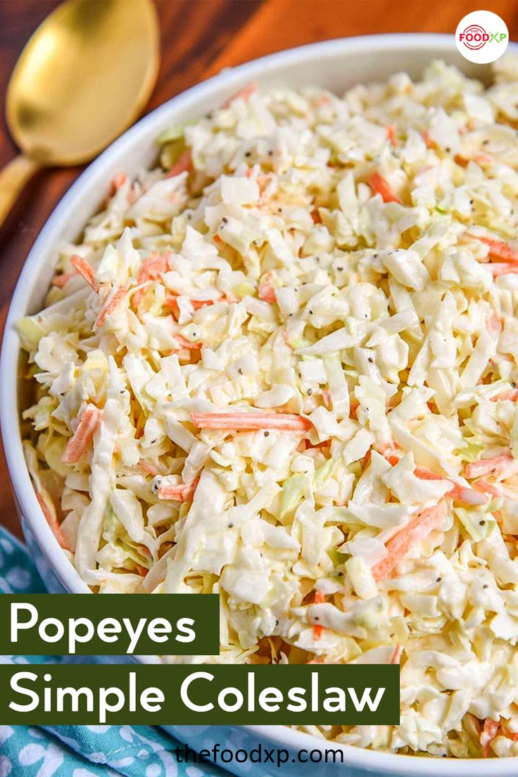 a bowl filled with coleslaw on top of a wooden table