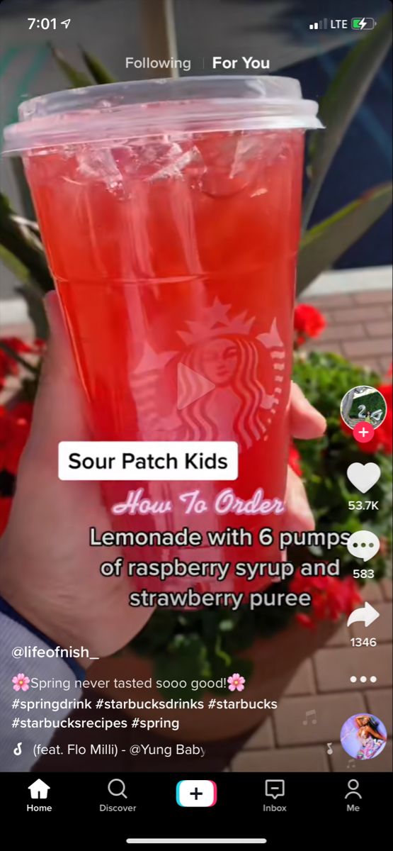 someone holding up a cup of tea with the caption sour patch kids lemonade with 6 pumpkins, raspberry syrup and strawberry juice