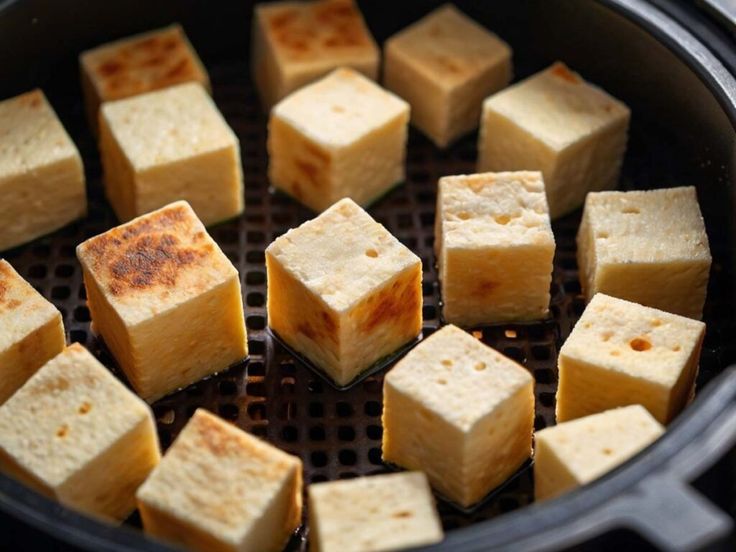 cubes of tofu cooking in an air fryer