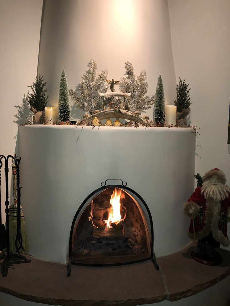 a fireplace is lit and decorated with christmas decorations