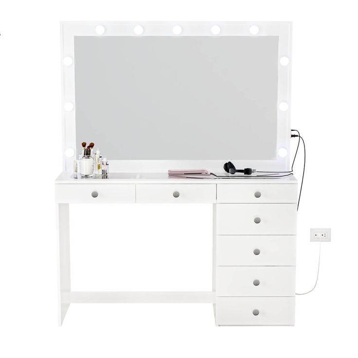 a white vanity with lights and drawers