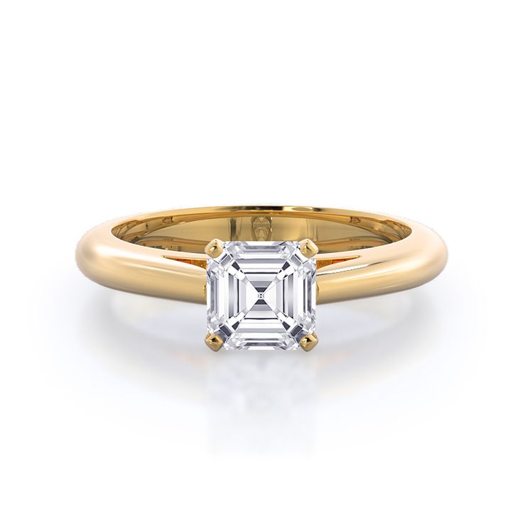 a rose gold ring with an emerald cut diamond in the center, on a white background