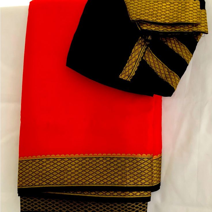 New And Beautiful And Bright Tomato Red With Black Border. Rich Pallu And Comes Ready To Wear And Glow With Pre Stitched Blouse Festive Red Saree With Border, Elegant Red Saree With Border, Red Silk Dupatta For Formal Occasions, Formal Red Dupatta, Red Saree With Border For Puja, Red Dupatta With Border For Puja, Red Saree With Border For Traditional Ceremonies, Red Silk Saree With Border, Red Silk Traditional Wear With Border