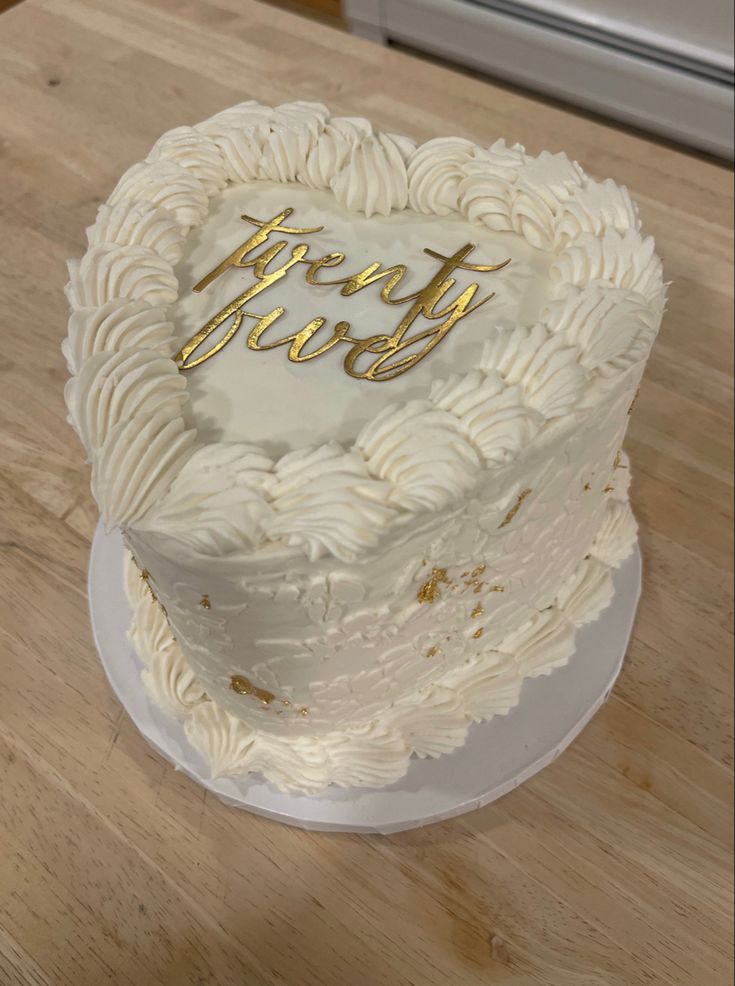 a heart shaped cake sitting on top of a wooden table