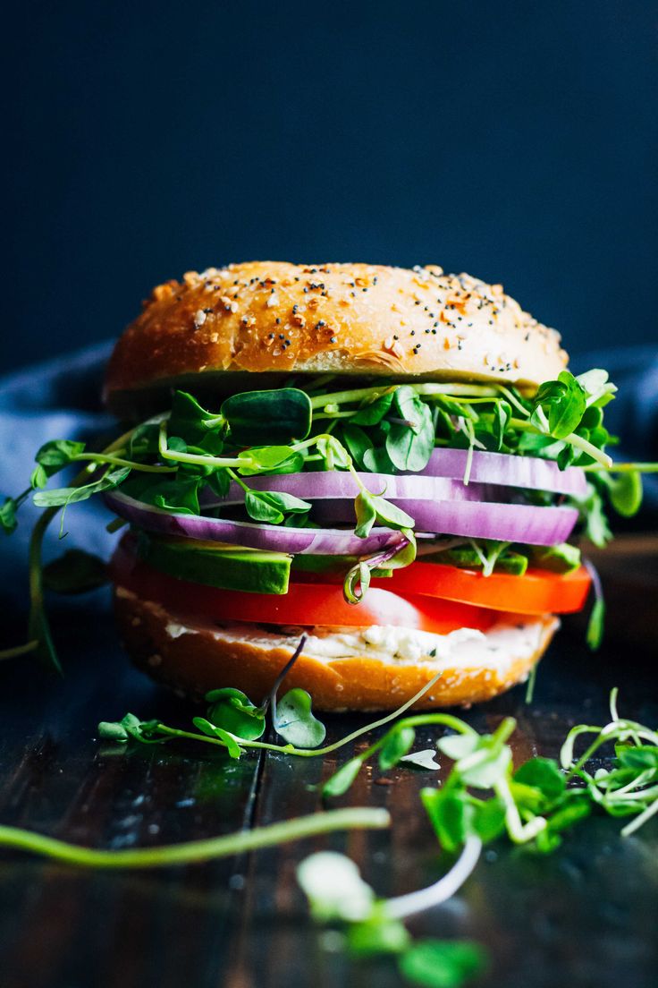 a close up of a sandwich with veggies on it