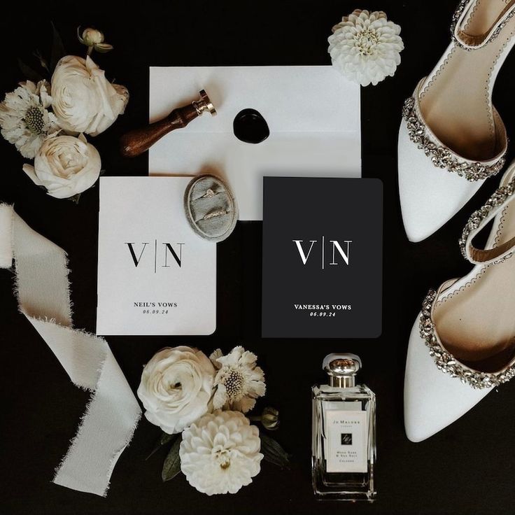 the contents of a wedding suite including shoes, perfume bottle and flowers on a black background