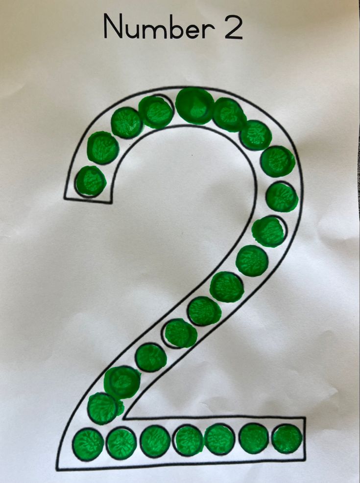 a paper bag with the number 2 drawn on it and green polka dots in the middle