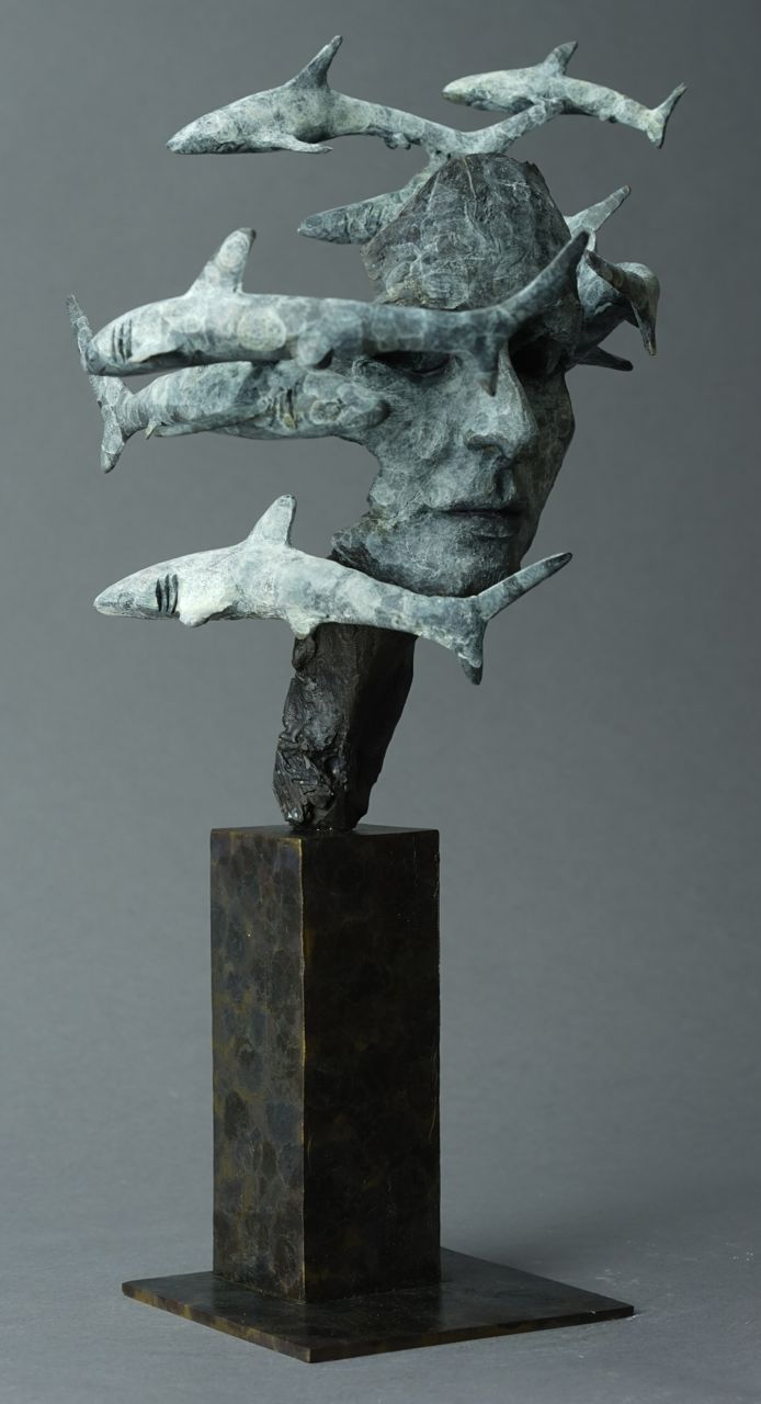 a bronze sculpture with multiple pieces of metal on it's head and body in the air