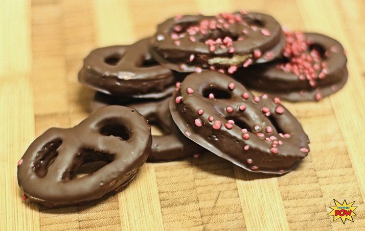 chocolate covered donuts with sprinkles on a table