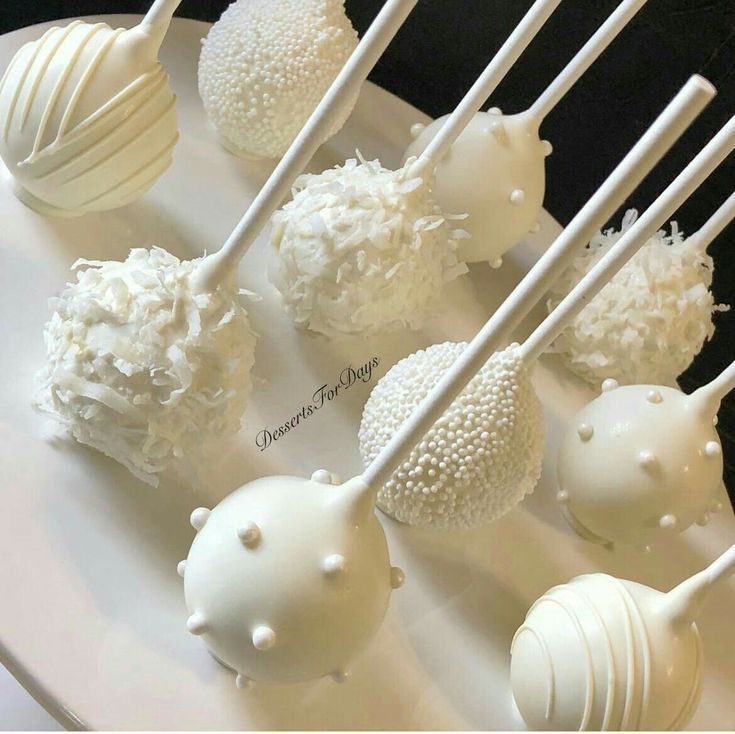 there are many white cake pops on the plate