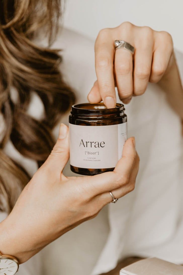 a woman holding a jar of arraie in her hands