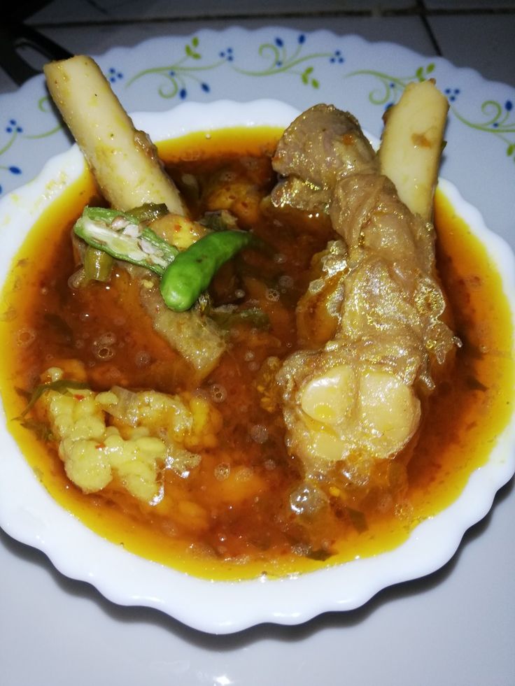 a white bowl filled with food on top of a table