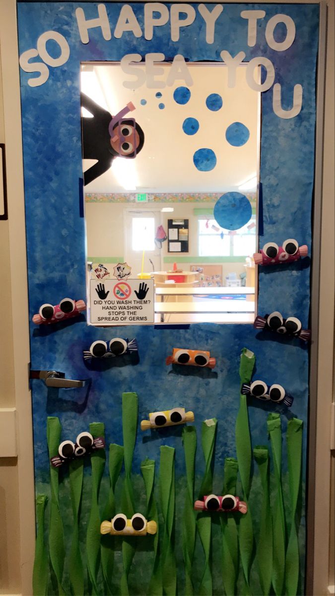 a classroom door decorated with green grass and sunglasses