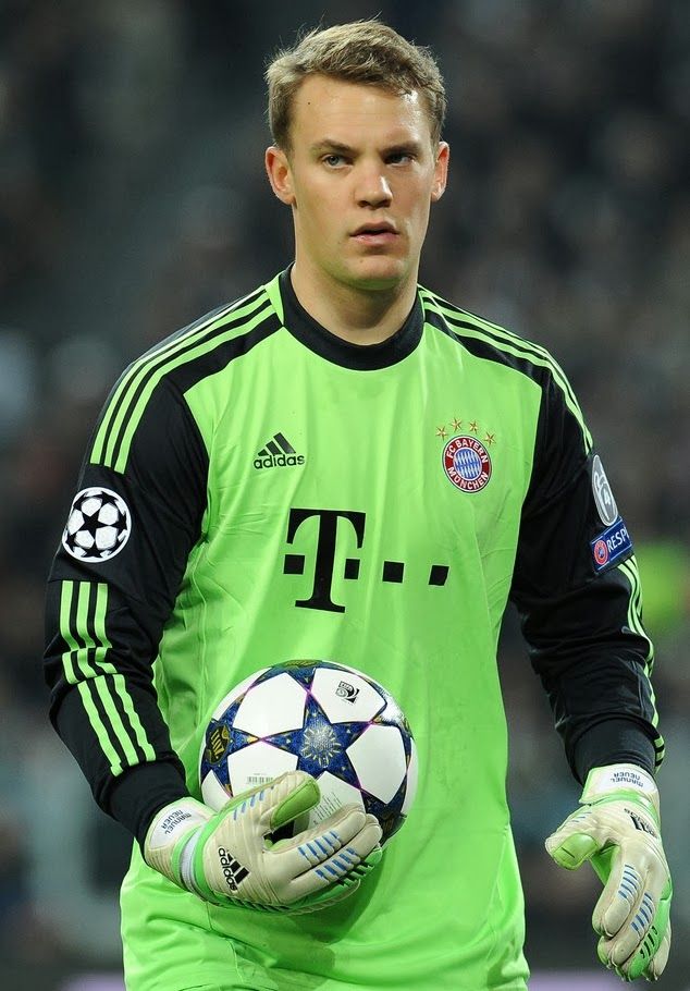 a man holding a soccer ball on top of a field