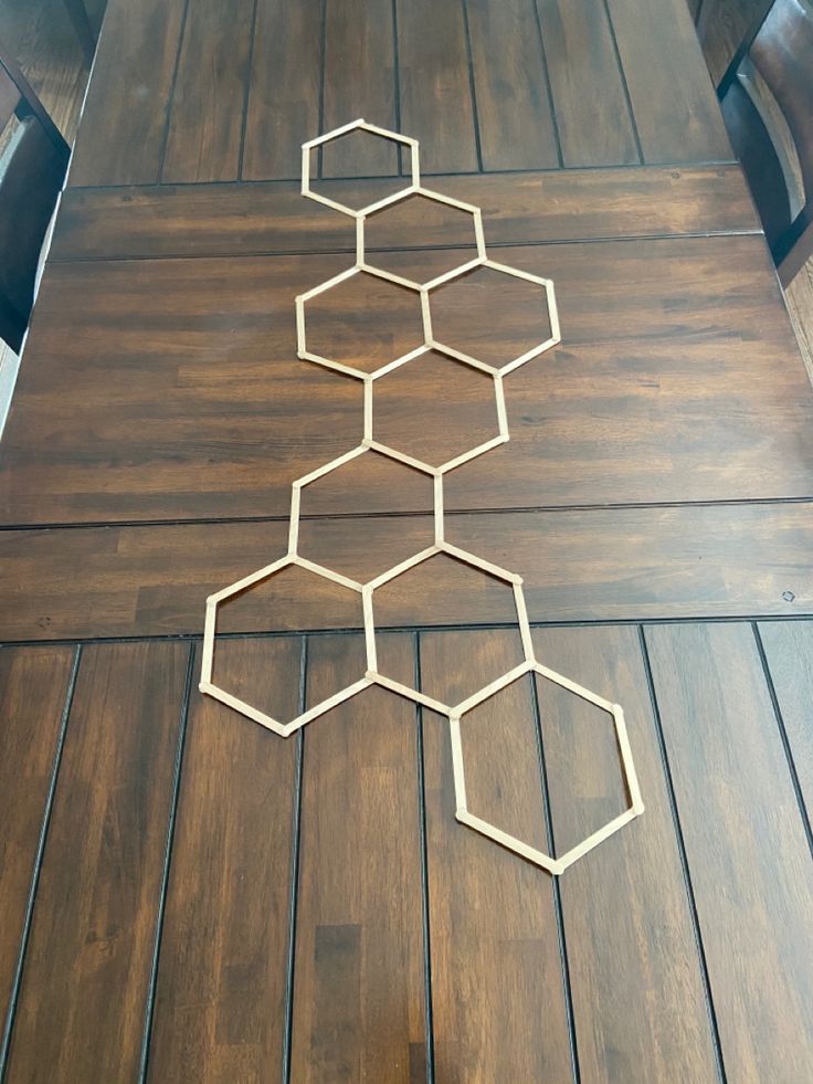 the table is made out of hexagons on top of wood flooring