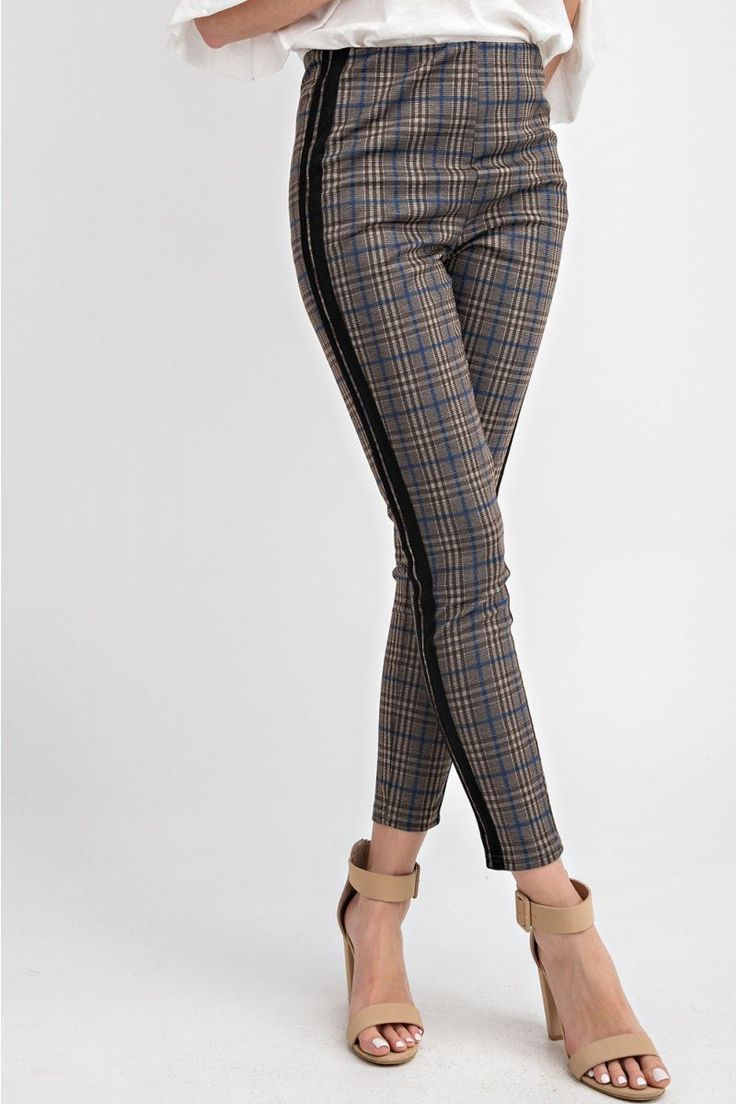 The Plaid Me Up ponte skinny pants/leggings are a classic with a twist that are so easy to wear with a stretchy waistband. The black racer stripe up the side of the leg adds a fun twist to a classic plaid. We love this styled with our Sophie turtleneck tunic or the Mia cowl neck. Offered in Olive 97% polyester, 3% spandex Imported Model is 5'8" and wearing a small Recommend to size up for a not so skinny fit Olive color option has the blue stripe detail Ash gray color option has the pink stripe Plaid Pants Outfit, Pants Outfit Work, 60’s Fashion, Plaid Pants Women, Winter Pants Outfit, Turtleneck Tunic, Leg Pants Outfit, Black Racer, Ponte Leggings