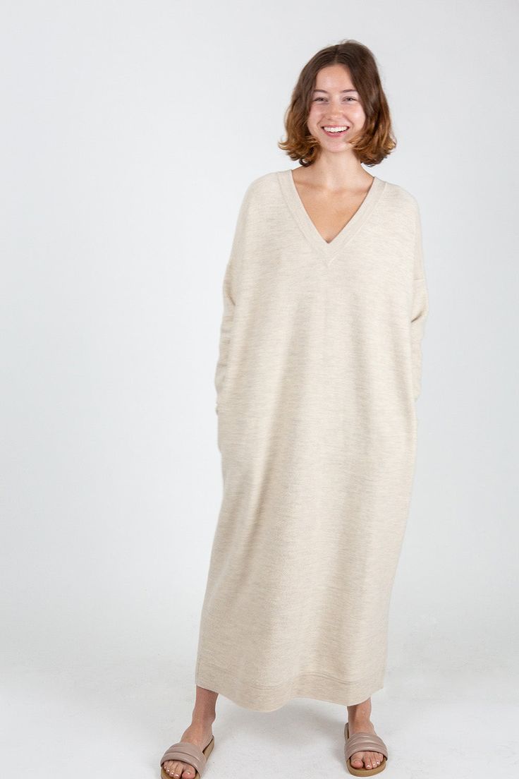 Brushed knit merino wool blend dress with side seam pockets and ribbing at v neck, hem, and cuffs.Lauren Manoogian Details Made in Peru. 63% Merino Wool 27% Alpaca 10% Lycra. Hand wash cold with mild soap and lay flat to dry. Do not bleach. Chic V-neck Sweater Dress For Loungewear, Cream V-neck Sweater Dress For Fall, Oversized V-neck Midi Dress For Daywear, Fall Cream V-neck Sweater Dress, Spring V-neck Sweater Dress For Loungewear, Oversized V-neck Sweater Dress For Spring, V-neck Sweater Dress For Fall Loungewear, Fall Sweater Dress V-neck For Loungewear, Knit V-neck Sweater Dress For Loungewear