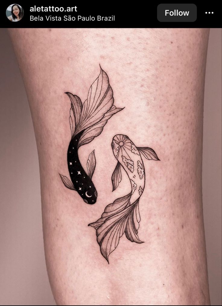 a woman's thigh with two goldfish tattoos on her legs, one is black and the other is white