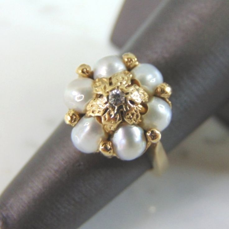 A Womens Vintage Estate 14k Gold Pearl & Diamond Ring. The Ring Is A Size 5.75, And Weighs 8.7g. The Diamond Is About .05cts. Not Sure If The Pearls Are Real Or Man Made. Setting Of The Ring Is Gorgeous. Ring Is Faintly Marked 14k. Any Questions, Please Don't Hesitate To Ask. Be Sure To Check Out Some Of My Other Great Items Up For Sale. Thank You. Luxury 14k Gold Pearl Ring With Diamond Accents, Luxury Vintage Gold Pearl Ring, Antique Yellow Gold 14k Pearl Ring, Vintage Gold Hallmarked Pearl Ring, Vintage Multi-stone Pearl Ring For Formal Occasions, Pearl And Diamond Ring, Pearl Diamond, Gold Pearl, Womens Jewelry Rings