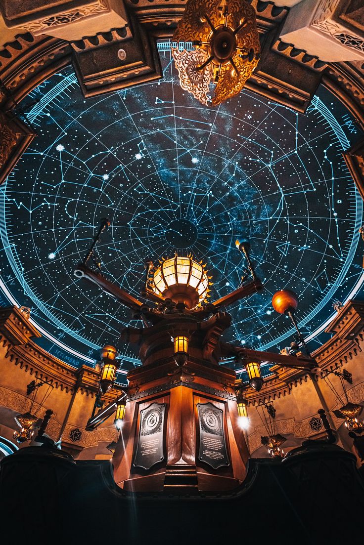 an overhead view of a clock tower in a building with many stars on the ceiling