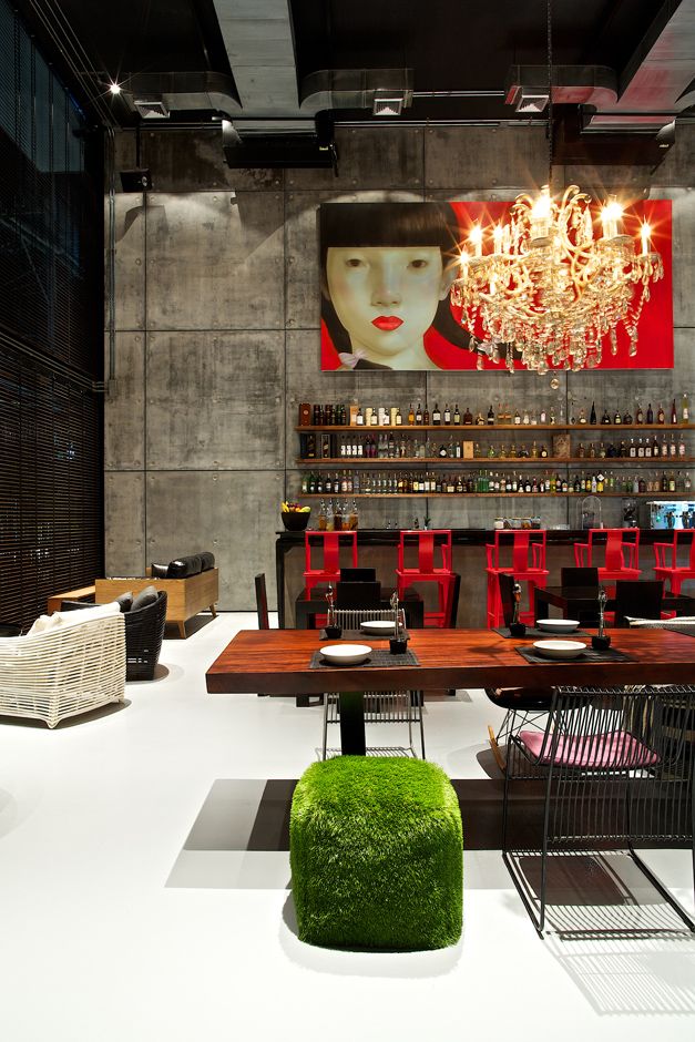 the interior of a restaurant with tables, chairs and chandelier