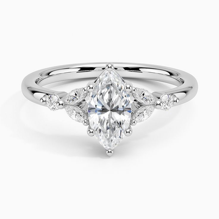 Marquise Cut Verbena Diamond Engagement Ring - 18K White Gold. This feminine, nature-inspired ring features four dazzling marquise-shaped diamonds elegantly accenting a center gem in a bead prong basket setting. Round diamond accents sparkle from the shoulders (1/6 total carat weight). Timeless Marquise Diamond White Diamond Ring, Dazzling Marquise Diamond Promise Ring, Dazzling Marquise Diamond Ring In Diamond White, Dazzling Marquise Diamond White Ring, Marquise Cut Lab Grown Diamond Wedding Ring, Marquise Cluster Ring With Accent Stones For Wedding, Marquise Cut Lab Grown Diamond Wedding Ring With Accents, Lab Grown Diamond Wedding Ring With Marquise Cut, Marquise Cut Lab Grown Diamond Ring With Accents