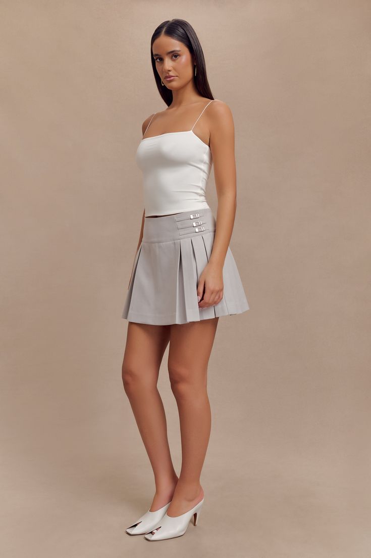 Timelessly tailored.The ANGIE Pleated Buckle Mini Skirt is a playful yet polished addition to your wardrobe, designed to turn heads. This skirt features a wide waistband with a striking buckle detail, adding a touch of sophistication and a flattering fit. The side zip and hook-and-eye closure ensure a seamless silhouette, while the pleated design and mini length create a dynamic, feminine shape. For a chic daytime look, pair it with the Aspen Suiting Vest, or elevate the ensemble with the Bellam Capsule Wardrobe Accessories, Workwear Capsule Wardrobe, Workwear Capsule, European Summer Outfits, Wardrobe Accessories, Maxi Dress Sale, Capsule Outfits, Spaghetti Strap Top, Straight Neckline