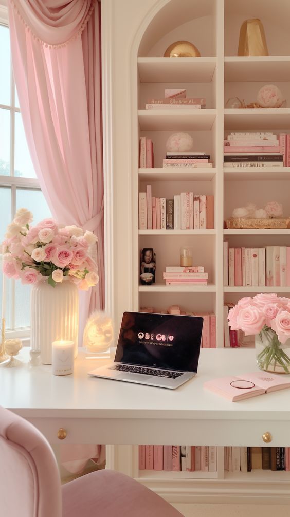 a laptop computer sitting on top of a white desk in front of a book shelf