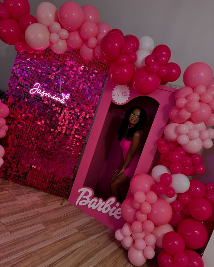 a barbie birthday party with pink and white balloons