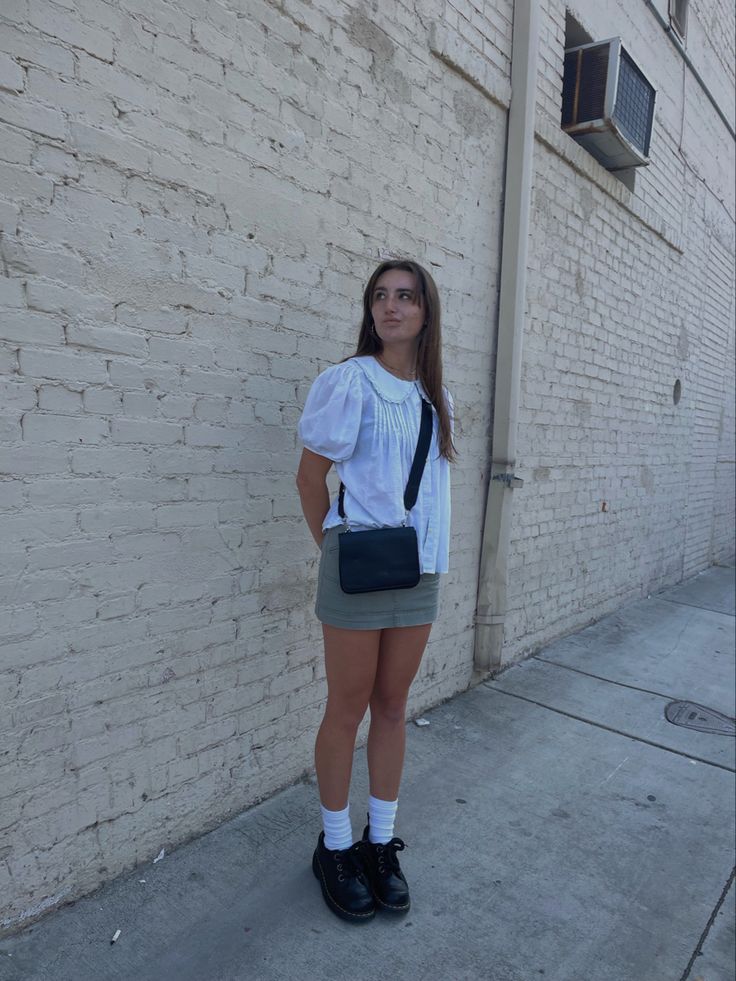 girl in dr martens, green cargo mini skirt and white ruffle shirt posing in front of white brick wall Brick Wall Photoshoot Ideas, Brick Wall Photoshoot, Wall Photoshoot, White Brick Wall, Downtown Aesthetic, Aesthetic Fit, Pic Inspiration, Aesthetic Fits, White Brick