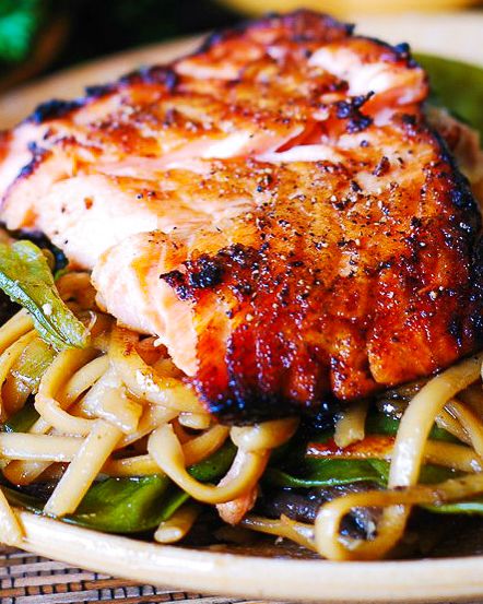 a plate with noodles, meat and vegetables on it