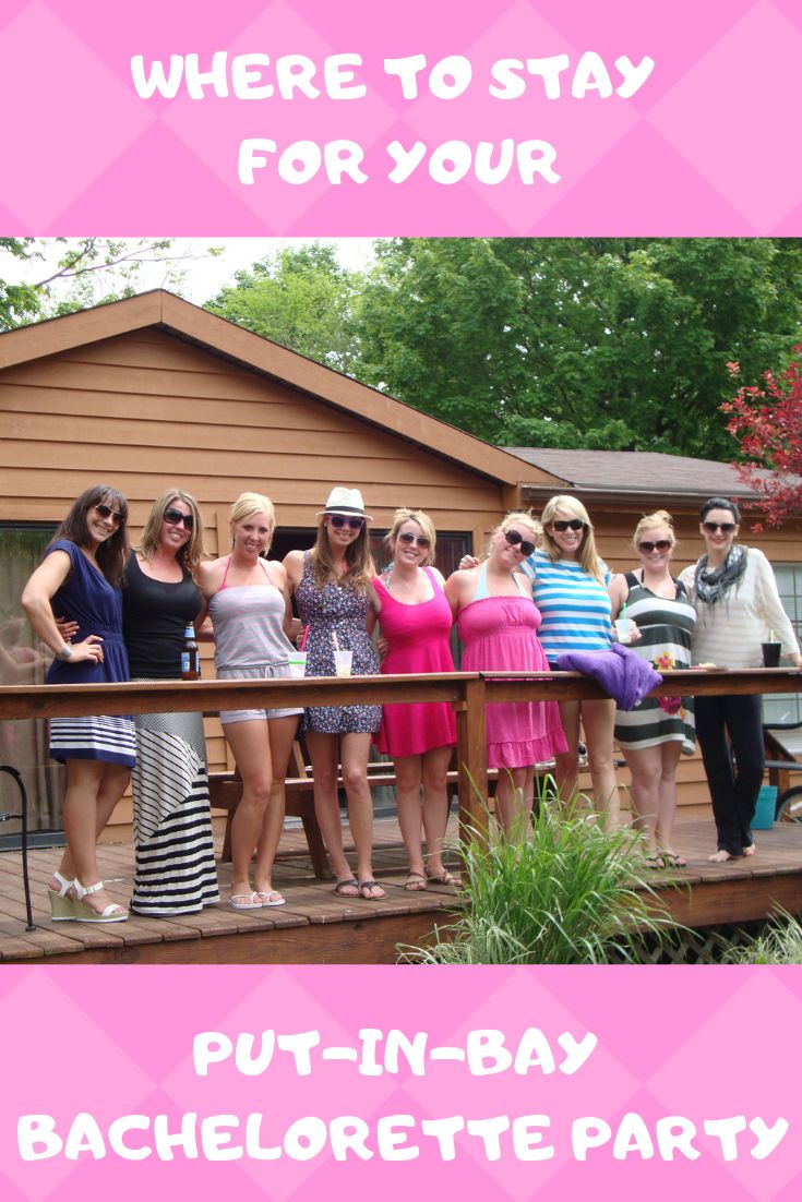 a group of women standing on top of a wooden deck in front of a house