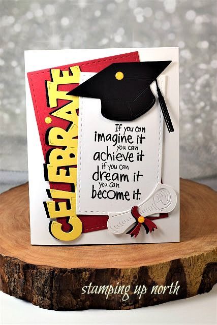 a graduation card on top of a tree stump